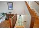 Stairwell with a light fixture, hardwood stairs, and wooden railing leading to landing at 2502 Kerry Ne Ct, Marietta, GA 30066