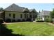 Beautiful backyard view with lush lawn and well-maintained landscaping at 4019 Hickory Fairway Dr, Woodstock, GA 30188