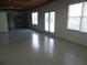 Unfinished basement area with painted concrete floors, shelving and glass doors at 4019 Hickory Fairway Dr, Woodstock, GA 30188