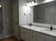 Bathroom with double sink vanity with granite countertops and modern fixtures at 4019 Hickory Fairway Dr, Woodstock, GA 30188