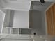 Bright walk-in closet with white shelving and gold hardware, providing ample storage space with access door at 4019 Hickory Fairway Dr, Woodstock, GA 30188