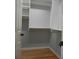 Walk in closet with custom shelving and wooden floor at 4019 Hickory Fairway Dr, Woodstock, GA 30188