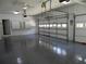 Spacious three-car garage with epoxy flooring, ample storage cabinets, and an automatic door opener at 4019 Hickory Fairway Dr, Woodstock, GA 30188