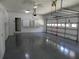 Spacious three-car garage with epoxy flooring, ample storage cabinets, and an automatic door opener at 4019 Hickory Fairway Dr, Woodstock, GA 30188