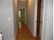 View of hallway featuring hardwood floors with door leading into a room with bright windows at 4019 Hickory Fairway Dr, Woodstock, GA 30188