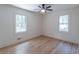 Bright bedroom with hardwood floors, two windows, and neutral-toned walls at 810 Parkway Se Dr, Smyrna, GA 30080