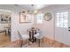 Charming dining area features hardwood floors, a modern light fixture, and a round glass table at 810 Parkway Se Dr, Smyrna, GA 30080