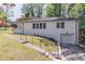 Charming white brick home with an attached garage and a landscaped front yard on a sunny day at 810 Parkway Se Dr, Smyrna, GA 30080