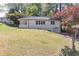 Picture-perfect home boasting a garage, lush lawn, and beautiful trees surrounding the property at 810 Parkway Se Dr, Smyrna, GA 30080