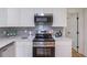 Updated kitchen features stainless steel appliances, white cabinets, and modern backsplash at 810 Parkway Se Dr, Smyrna, GA 30080