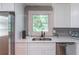 This is an updated kitchen with stainless steel appliances, white cabinets, and a view from the window at 810 Parkway Se Dr, Smyrna, GA 30080
