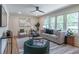 Bright living room with large windows, stylish furniture, and modern decor in a neutral palette at 810 Parkway Se Dr, Smyrna, GA 30080