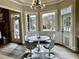 Bright breakfast nook with modern chandelier, sleek table with seating for four, and multiple windows at 216 Slate Dr, Buford, GA 30518