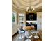 Cozy breakfast nook with modern light fixture, backyard views and updated chairs at 216 Slate Dr, Buford, GA 30518
