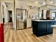 Open kitchen features a large center island with stone accents and modern appliances at 216 Slate Dr, Buford, GA 30518