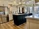 Spacious kitchen features a large island, built-in wine rack and stainless steel appliances at 216 Slate Dr, Buford, GA 30518