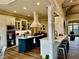 Open kitchen features a center island, counter seating, and stainless steel appliances at 216 Slate Dr, Buford, GA 30518