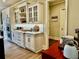 Bright kitchen features a breakfast bar, white marble counters and custom cabinetry at 216 Slate Dr, Buford, GA 30518
