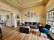 Inviting living room with hardwood floors, wainscotting, and modern furnishings at 216 Slate Dr, Buford, GA 30518