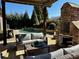 An outdoor patio with stone fireplace overlooking a beautiful pool at 216 Slate Dr, Buford, GA 30518