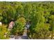 Aerial view showing a well-maintained home with driveway surrounded by beautiful trees, set on a peaceful lot at 1200 Taylor Oaks Dr, Roswell, GA 30076