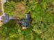 Aerial view of a house showcasing its roof, surrounded by lush trees in a tranquil neighborhood setting at 1200 Taylor Oaks Dr, Roswell, GA 30076