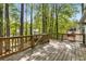 Large wooden deck overlooking backyard surrounded by towering trees offering a tranquil space for outdoor entertaining and relaxation at 1200 Taylor Oaks Dr, Roswell, GA 30076