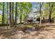 Beautiful backyard view with a lush tree line and a deck with stairs leading to a peaceful outdoor space at 1200 Taylor Oaks Dr, Roswell, GA 30076