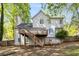 Exterior of the home featuring a deck, stairs, and a spacious backyard ideal for outdoor entertaining and Gathering gatherings at 1200 Taylor Oaks Dr, Roswell, GA 30076