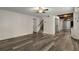 Basement living area features wood flooring, a staircase, storage, and access to a kitchen area at 1200 Taylor Oaks Dr, Roswell, GA 30076