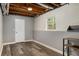 Finished basement with wood flooring, a door to outside, and two-tone painted walls at 1200 Taylor Oaks Dr, Roswell, GA 30076
