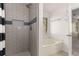 Bathroom featuring a combination shower and tub setup with tiled walls and window at 1200 Taylor Oaks Dr, Roswell, GA 30076