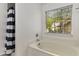 Bathroom with a shower/tub combo and window at 1200 Taylor Oaks Dr, Roswell, GA 30076