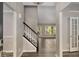 Welcoming entryway with dark floors, staircase, and abundant natural light at 1200 Taylor Oaks Dr, Roswell, GA 30076