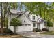 Charming home featuring a two-car garage and a well-manicured lawn at 1200 Taylor Oaks Dr, Roswell, GA 30076