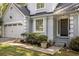 Inviting entrance with gray facade and landscaping, creating curb appeal at 1200 Taylor Oaks Dr, Roswell, GA 30076