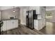 Modern kitchen with stainless appliances, granite counters, and view into living room at 1200 Taylor Oaks Dr, Roswell, GA 30076