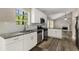 Bright kitchen with stainless appliances, granite counters, and view into living room at 1200 Taylor Oaks Dr, Roswell, GA 30076