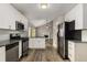 Open kitchen with stainless steel appliances, white cabinets, and granite countertops at 1200 Taylor Oaks Dr, Roswell, GA 30076
