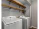 Laundry room with shelving and white side-by-side washing machine and dryer at 1200 Taylor Oaks Dr, Roswell, GA 30076