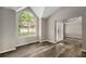 Living room with large window and dark laminate flooring at 1200 Taylor Oaks Dr, Roswell, GA 30076