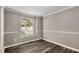 Neutral room with hardwood floors and white trim features a large window at 1200 Taylor Oaks Dr, Roswell, GA 30076