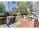 Inviting back deck with grill, cozy seating, and wooden railing offers a perfect spot for outdoor dining and entertaining at 2982 Ringle Rd, Brookhaven, GA 30341