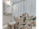 Cozy bathroom featuring bird-themed curtain, pedestal sink, and tiled walls offers a compact yet stylish design at 2982 Ringle Rd, Brookhaven, GA 30341