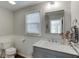Stylish bathroom features a marble countertop, paneled walls, and a large mirror, combining classic charm with modern elegance at 2982 Ringle Rd, Brookhaven, GA 30341
