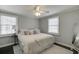 Comfortable bedroom features two windows, soft carpeting, a ceiling fan and neutral tones, creating a relaxing space at 2982 Ringle Rd, Brookhaven, GA 30341