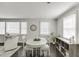 Dining area featuring an elegant white round table and chairs, and ample natural light at 2982 Ringle Rd, Brookhaven, GA 30341