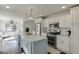 Open kitchen with a large island, white cabinetry and stainless steel appliances at 2982 Ringle Rd, Brookhaven, GA 30341