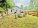 View of the backyard with lawn, privacy fence, and seating area at 4437 Janice Dr, Snellville, GA 30039