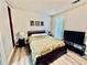 Cozy bedroom with natural light, hardwood floors, and a warm decor at 4437 Janice Dr, Snellville, GA 30039